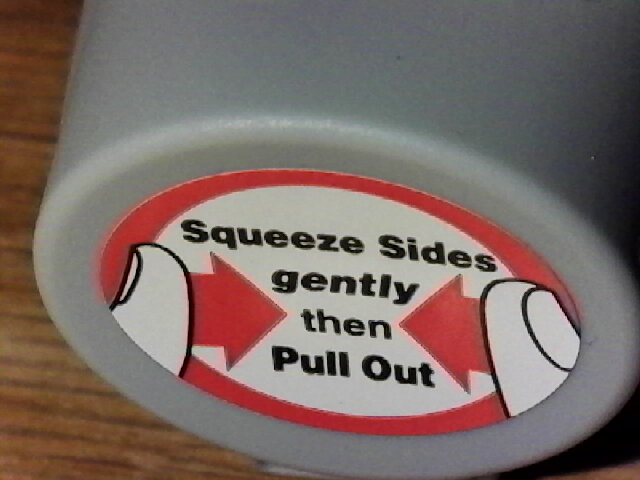 Mouthpiece cover with a sticker saying "Squeeze Sides gently then Pull Out"